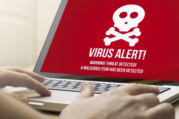 bitdefender antivirus plus 2020 security software red virus alert on monitor display on laptop hands typing